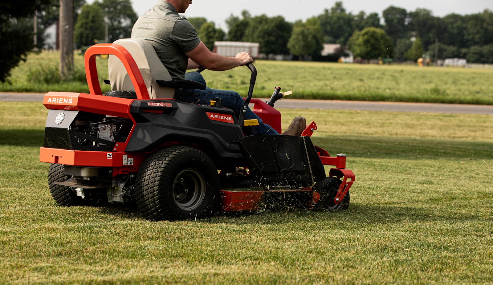 Riding mower cutting a lawn